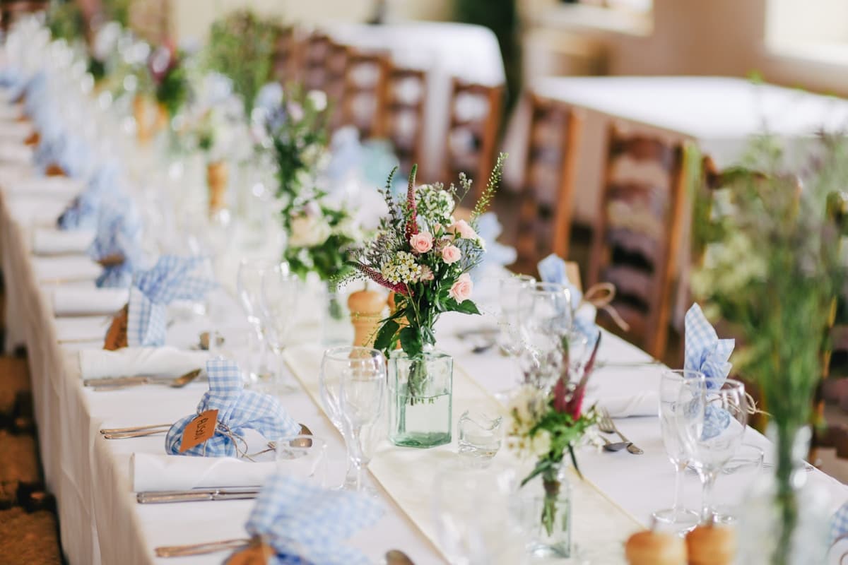 Thoughtfully arranged wedding reception table with flowers and candles